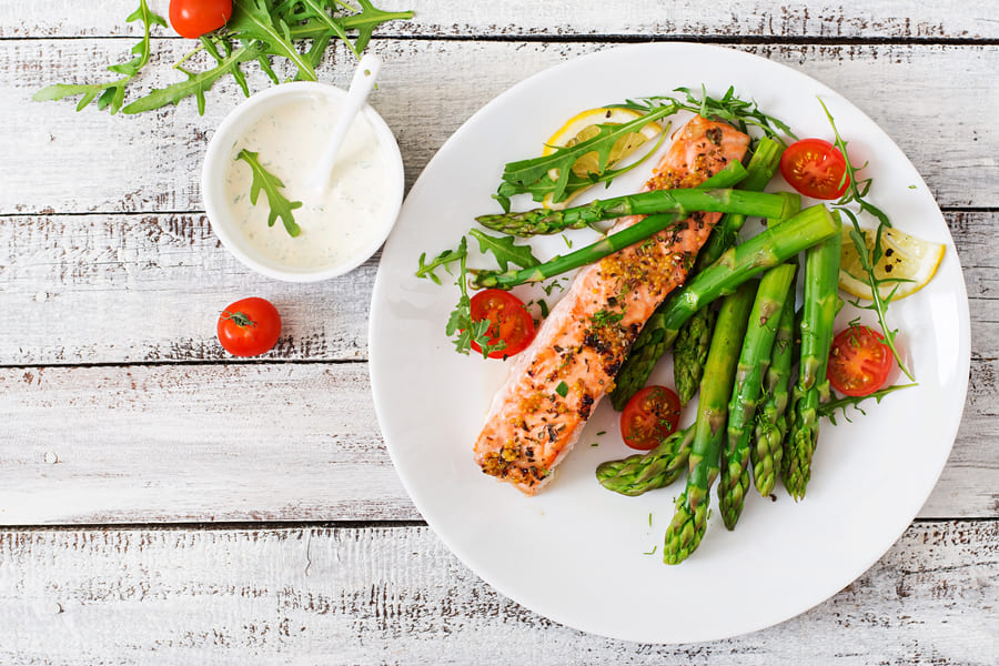 baked-salmon-garnished-with-asparagus-and-tomatoes-with-herbs-top-view (1).jpeg