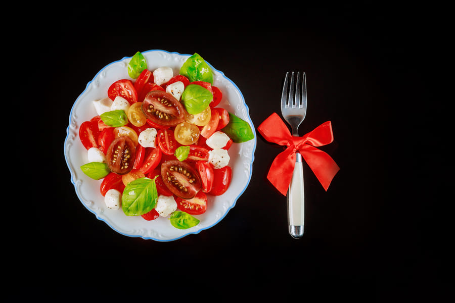 sliced-tomato-mozzarella-salad-with-fork-christmas-dinner-vegetarian-dish (1).jpeg