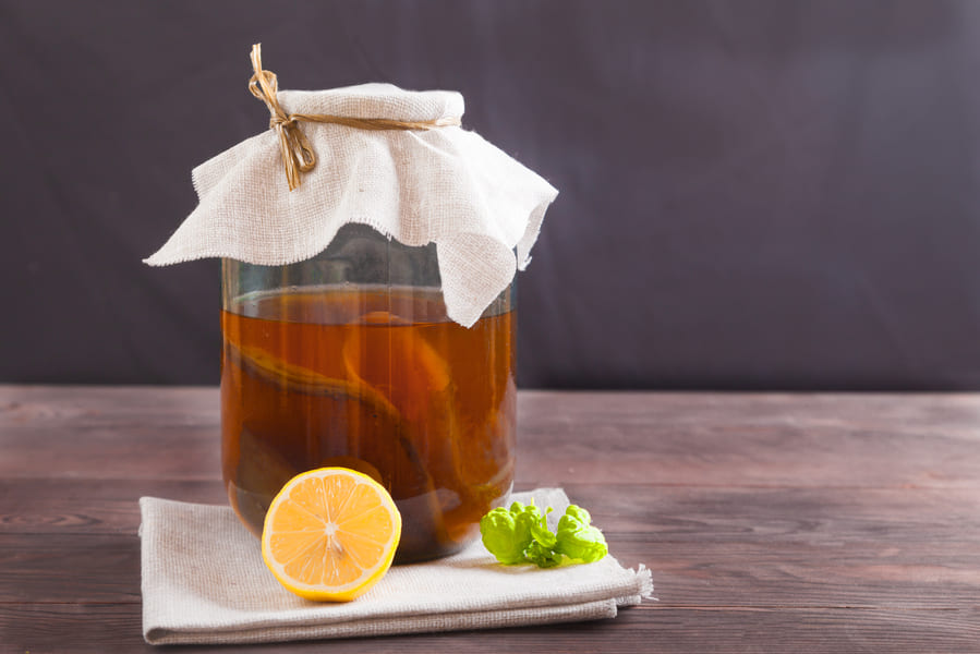 kombucha-glass-jar-lemon-mint-leaf-wooden-table-fermented-drink-healthy-food-concept (1).jpeg