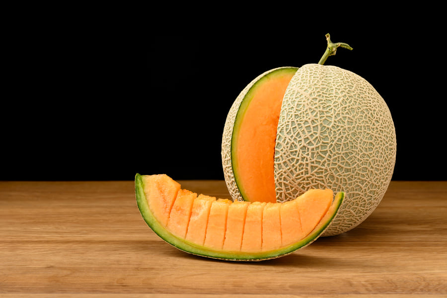 melon-fruit-sliced-wooden-table-with-black-background (1).jpeg