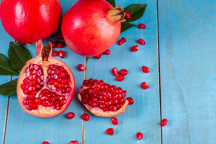 ripe-pomegranate-fruits-wooden-table (2).jpeg