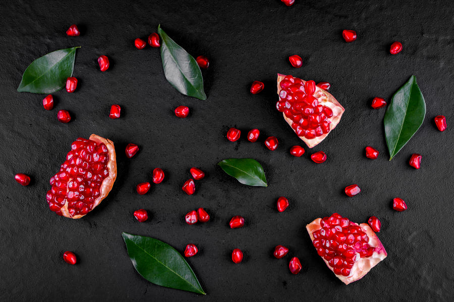 ripe-pomegranate-fruits-wooden-background (1).jpeg
