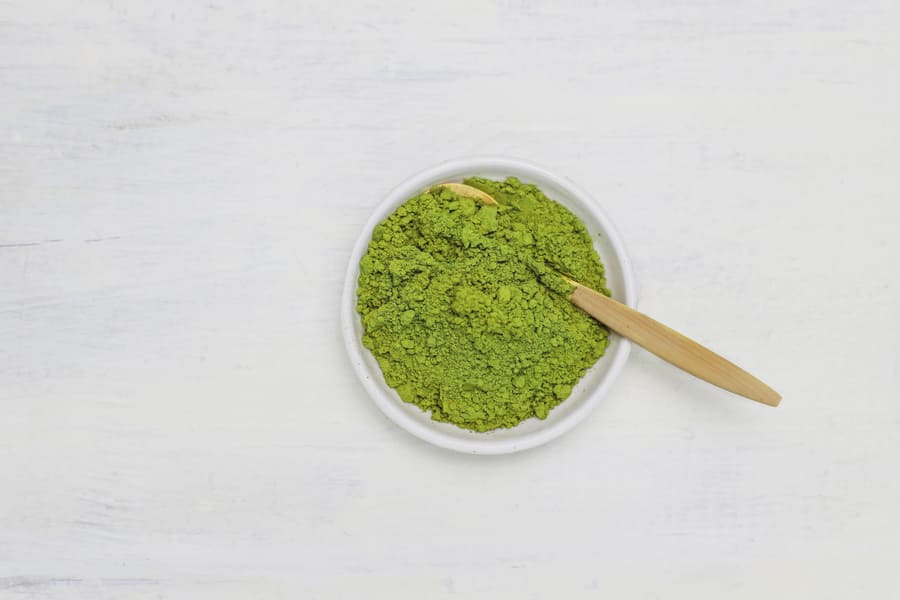 word-matcha-made-of-powdered-matcha-green-tea-and-bamboo-spoon-on-white-copy (1).jpeg