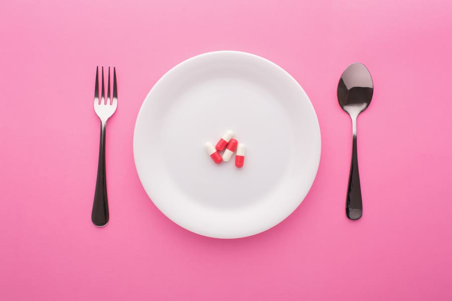 dietary-supplement-plate-with-fork-spoon-pink-top-view (1).jpeg