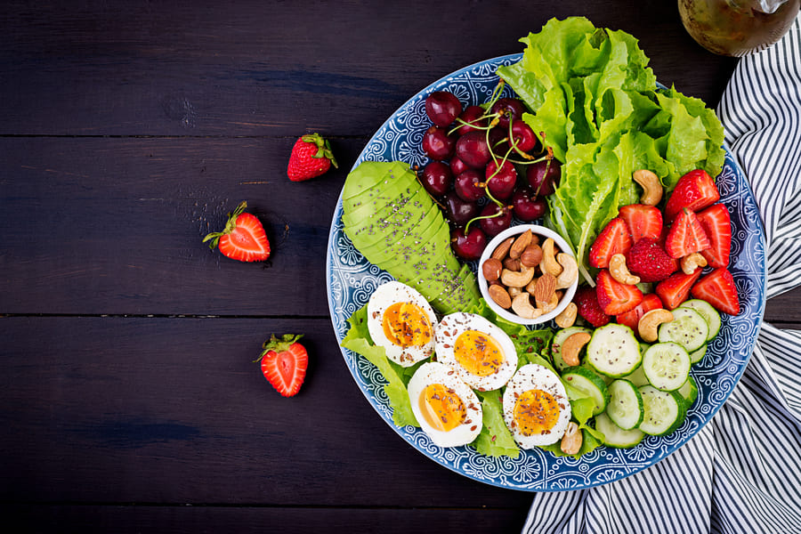 plate-with-paleo-diet-food-boiled-eggs-avocado-cucumber-nuts-cherry-strawberries-paleo-breakfast-top-view (1).jpeg