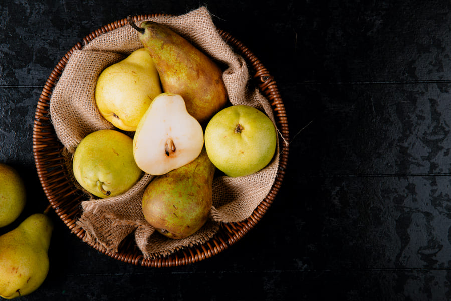 top-view-of-fresh-ripe-pears-in-a-wicker-basket-on-black-background-with-copy-space (1).jpeg