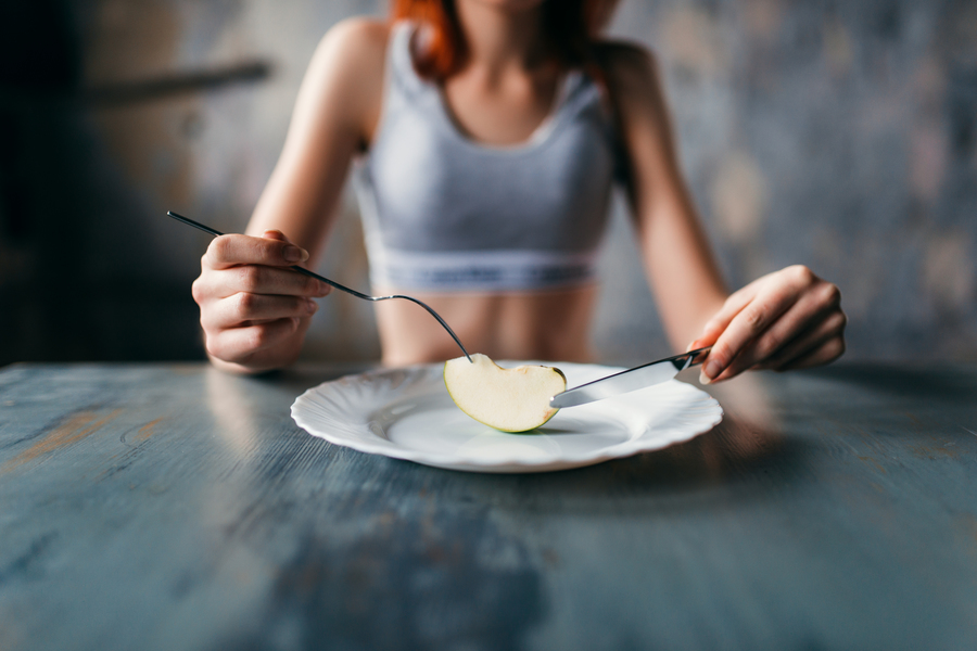 female-person-against-plate-with-slice-apple-weight-loss-diet-concept (1).jpeg