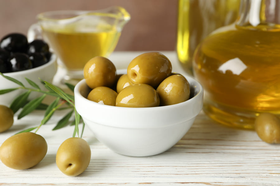 composition-with-olive-oil-olives-wooden-table-close-up (1).jpeg
