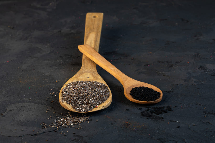 side-view-black-cumin-seeds-wooden-spoons-black (1).jpeg