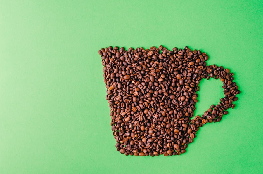 coffee-cup-made-coffee-beans-green-background-perfect-cool-wallpaper (1).jpeg