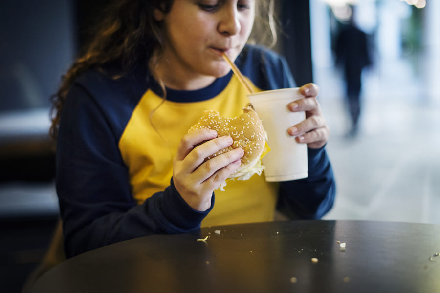 close-up-teenage-girl-eating-hamburger-obesity-concept (1).jpeg