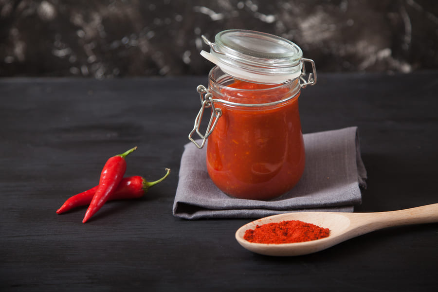 harissa-spicy-condiment-glass-jar-stands-gray-linen-napkin-wooden-spoon-with-spices-chili-pepper (1).jpeg
