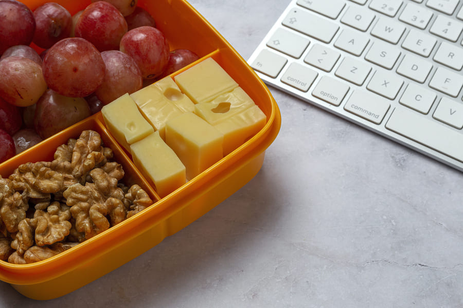 healthy-food-plastic-containers-ready-eat-with-cheese-grapes-walnuts-work-table-take-away-walnuts (1).jpeg