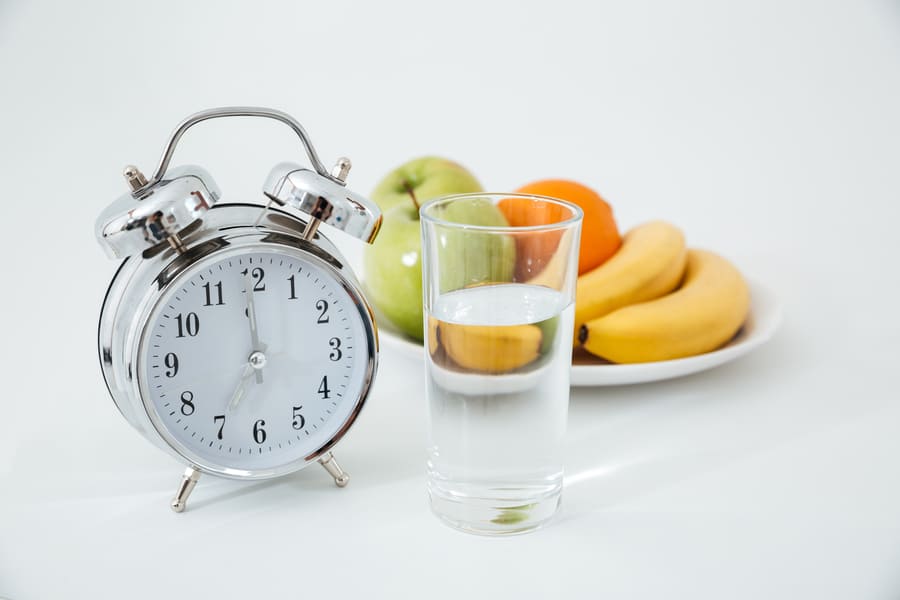 alarm-and-glass-of-water-near-fruits (1).jpeg