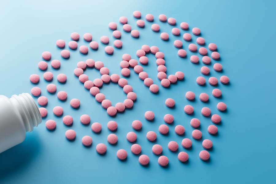 pink-pills-shape-letter-b12-blue-background (1).jpeg